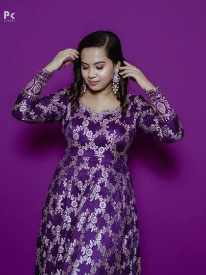 A close-up of the purple brocade Anarkali, showing the detailed hand embellishments.