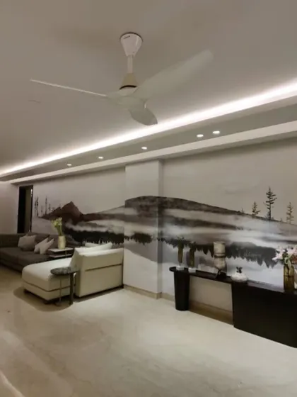 A serene, monochromatic landscape mural creates a sense of depth and tranquility in this spacious living room. This is a perfect example of how wallpaper can expand a room visually.