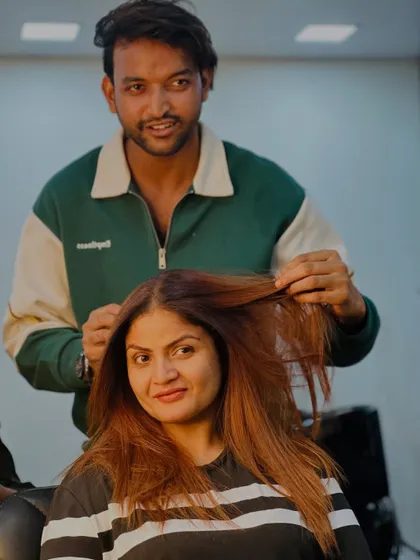 A moment of connection between our stylist and client after a successful transformation.