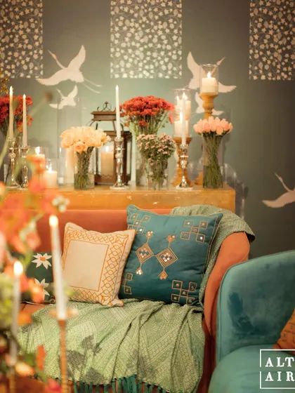 A close-up of the seating at 'Midnight Marrakesh', showing the mix of embroidered pillows, soft throws, and warm candlelight. Every detail contributed to the soulful, cozy atmosphere.