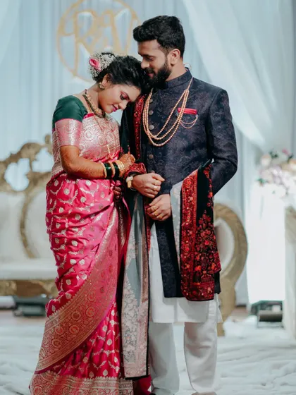 A quiet moment of 'sukoon' amidst the reception celebration. The bride rests her head on the groom's shoulder, a simple gesture full of love.