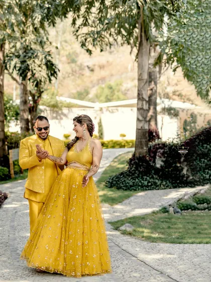 A candid moment of them sharing a dance and a laugh. The natural, outdoor setting and their joyful interaction make for a beautiful and authentic pre-wedding photograph.