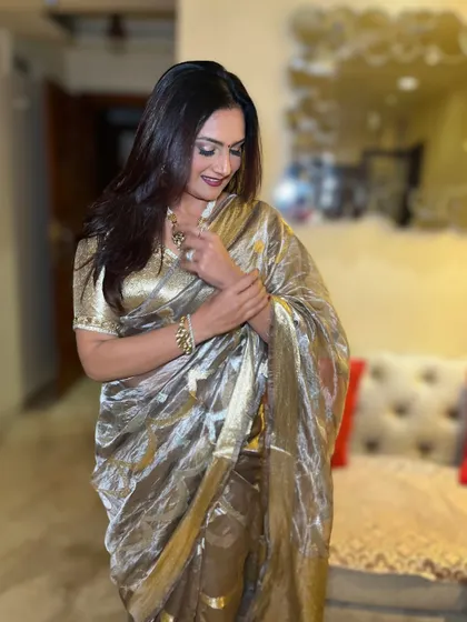 Saree, smile, and a whole lot of sass. This look features a glamorous metallic saree paired with a bold lip and radiant skin.