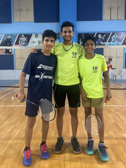 Two of our DSO under-17 players, Neel and Neev, with their coach. Competing at the district level is a key step in a player's development.