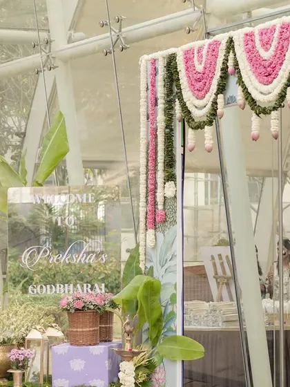 The entrance decor, featuring lush greenery and a beautiful floral toran, setting a traditional and welcoming tone.