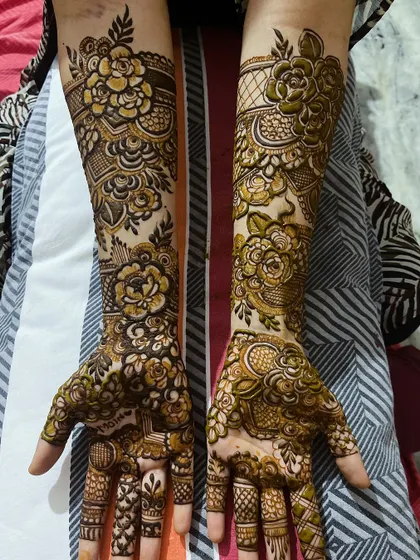 A full view of the floral henna design, showcasing the beautiful patterns on both hands.