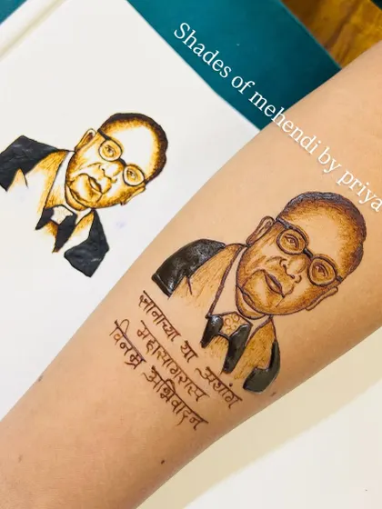 A henna portrait of Dr. Babasaheb Ambedkar, created from a reference sketch. The accompanying Marathi text adds a layer of respect and meaning to the design.