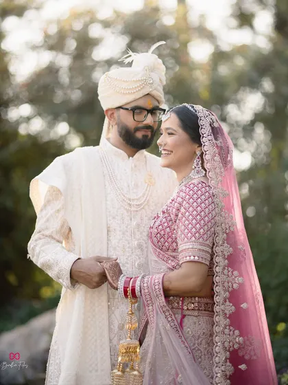 A classic and happy portrait of the bride and groom, captured in a beautiful outdoor setting with soft, natural light.