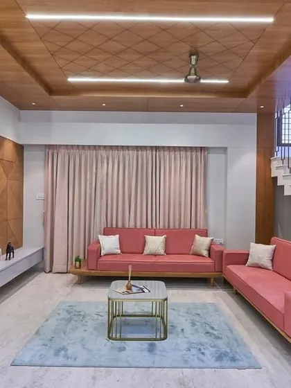 A closer look at the living area, showing the textured wood paneling on the TV wall and the patterned ceiling detail. These elements add layers of visual interest and a sense of bespoke craftsmanship.
