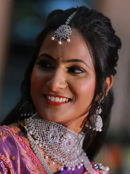 A candid shot of a bride's bright and happy smile during her wedding festivities.