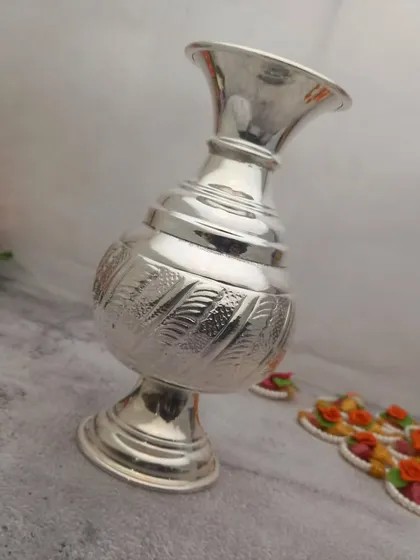 A German silver flower vase with a stand, featuring a modern design with traditional leaf-like engravings.