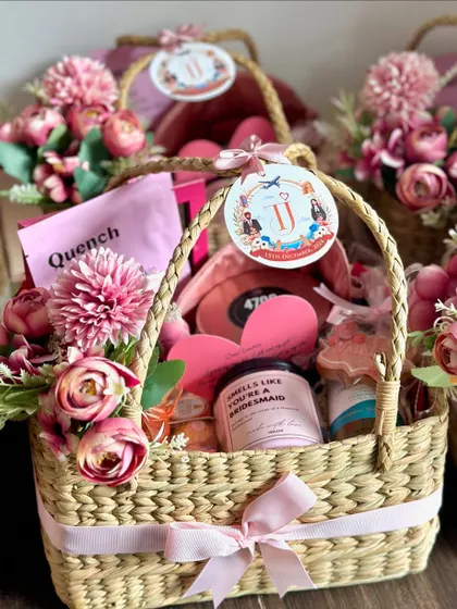 This is one of my all-time favorite bridesmaid proposal baskets! I fill these reusable wicker baskets with a beautiful floral arrangement and lots of pampering goodies to help you pop the question to your girls in the most special way.