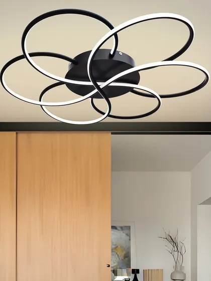 This modern floral ceiling light is made of interlocking black rings that form a flower shape. It's a bold and graphic design that adds a contemporary touch to any room.