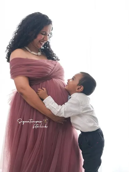 A son's adoration for his expectant mother, captured in a beautifully lit, tender moment.