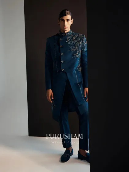 Transcend to a world of boundless brilliance. The details on this deep teal jacket, with its asymmetrical embroidery, are designed to capture and hold attention.