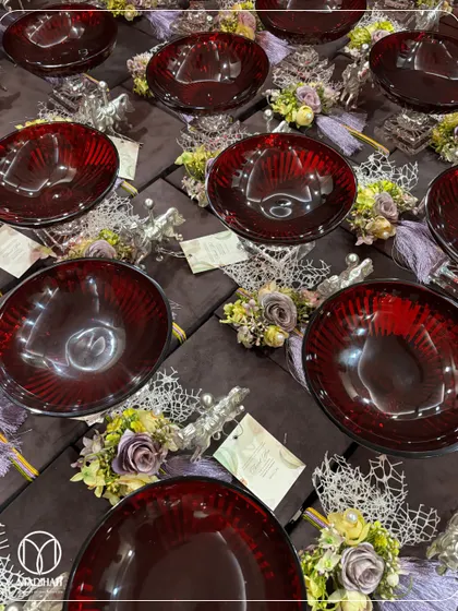 This image displays the contents of the purple velvet box, revealing a stunning ruby-red glass bowl. The contrast between the deep purple, the rich red, and the silver accents creates a truly regal and luxurious gift.