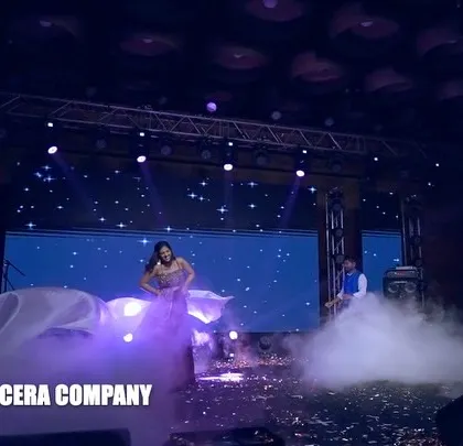 A wide shot of the sister's solo performance, showcasing the dramatic use of the cloth prop and smoke effects to create a magical atmosphere.
