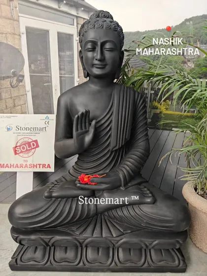 A full-length view of the 3-foot black marble Buddha, showing the detailed carving on the lotus base and the graceful flow of the robes.