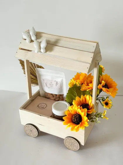 How adorable is this wooden cart hamper? We used it for a baby announcement and filled it with healthy snacks and decorated it with sunflowers.