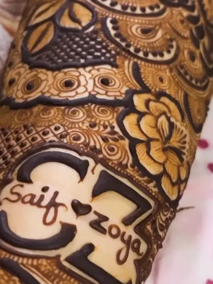 A bold and beautiful way to showcase your love. The names "Saif" and "Zoya" are the centerpiece of this intricate cuff design, making a clear and romantic statement.