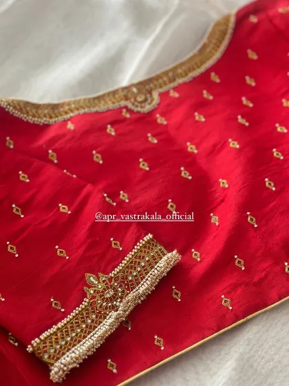 A view of the back of the simple red blouse.
