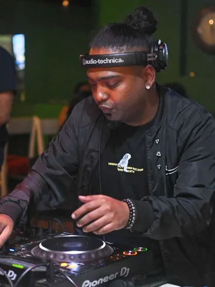 Focused on the mix at Jack's Bar. It's about blending tracks smoothly to keep the party's momentum going.