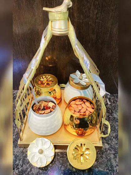 This is luxury gifting at its finest. I curated this set with four decorative jars, two in textured white ceramic and two in polished gold, all held within a beautiful golden tray with a bird-motif handle. It’s perfect for high-end corporate or wedding gifts.