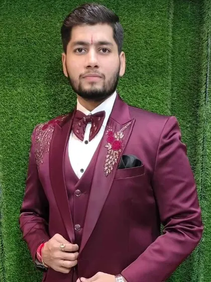 A happy customer in our maroon three-piece suit. The jacket features floral embroidery on the shoulder, adding a touch of festive elegance.