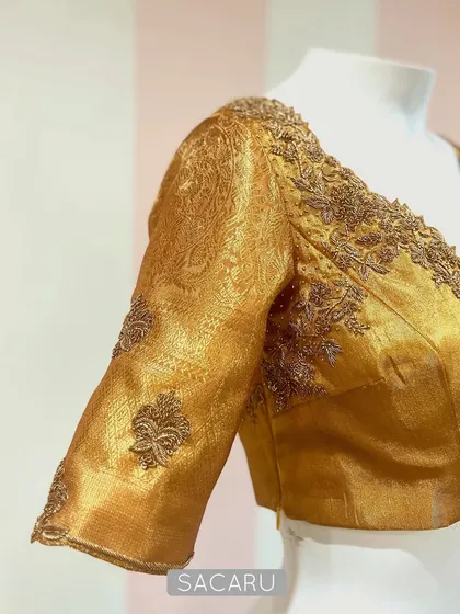 Dipped in gold. This blouse is made from a rich gold Benarasi fabric, with tonal embroidery along the neckline and sleeves for a subtle, luxurious finish.