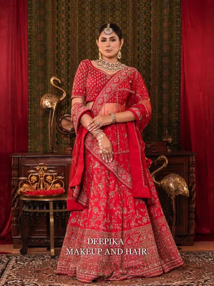 A full-length shot of the bride in her red lehenga, looking every bit the royal queen. The entire look is powerful and elegant.