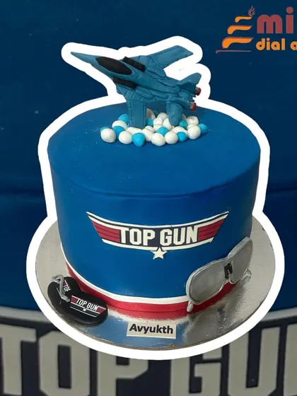 A high-flying cake for a Top Gun fan. This design features the movie's logo, a fighter jet topper, and cool aviator sunglasses, perfect for someone with a need for speed.