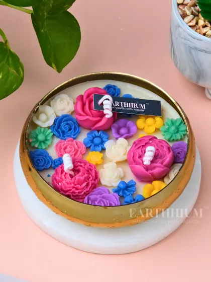 Another view of my technicolor floral Urli candle, showing the mix of pink, blue, and yellow flowers. Each one is uniquely arranged, so no two candles are exactly alike.