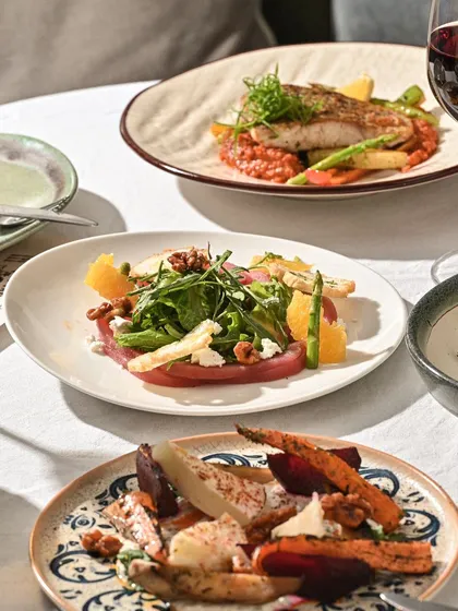 A table showcasing the variety of my Mediterranean-inspired menu, from salads to fish.