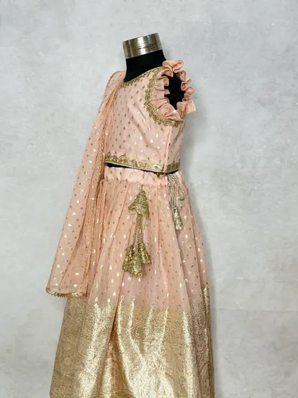A side profile of the periwinkle lehenga, showcasing the ruffled neckline and the lightweight dupatta.
