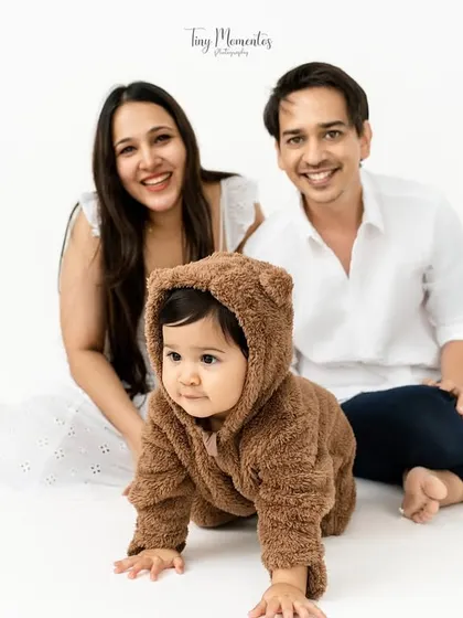 This little one in a fuzzy bear costume is ready for his adventure. With his parents smiling behind him, this shot captures the fun and playful side of family photography.