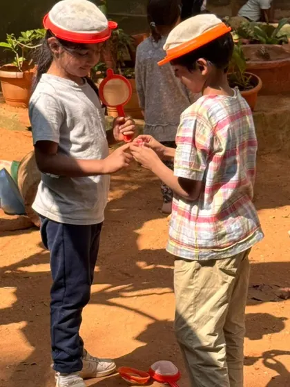 A pretend wedding ceremony is underway, with children exchanging rings made of found objects. This kind of imaginative play is how children explore social roles, relationships, and cultural traditions.