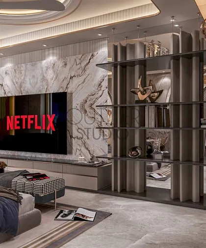This view of the master suite showcases the integrated media wall, featuring a book-matched marble panel and a contemporary open shelving unit that doubles as a stylish room divider.