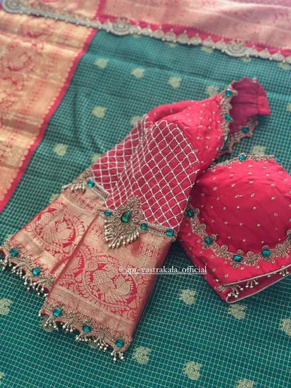 The full layout of the red blouse with green stone work.