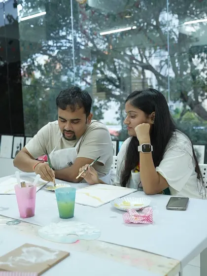 A couple works together on a painting during a workshop. Art is a wonderful way to connect and collaborate.