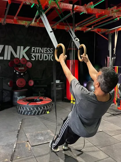 The TRX rings are an incredible tool for building upper body and core strength. This client is performing an inverted row, using his own bodyweight as resistance to work his back and biceps.