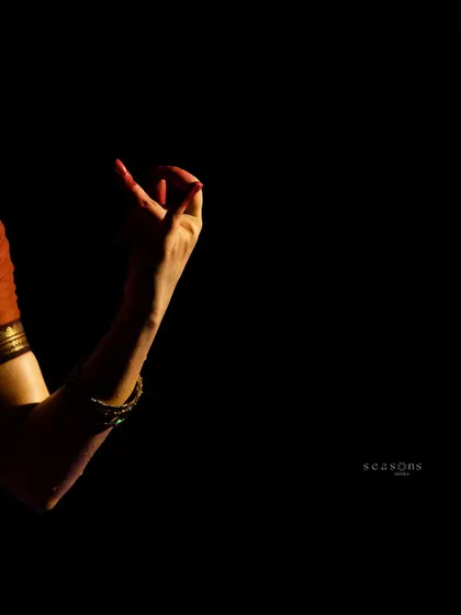 The delicate movement of a hand gesture, or mudra, captured in a moment of storytelling. Even the smallest details are crucial in conveying the narrative of a classical dance piece.