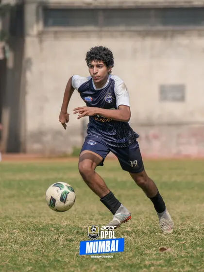 A player in full stride, dribbling with confidence and control.