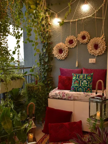 A cozy, green-filled look for the balcony, with lanterns and plush cushions.