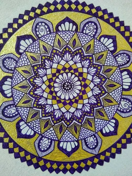 A full view of the violet and gold mandala, showcasing its complete circular pattern. The design flows from the center outwards, creating a sense of harmony.