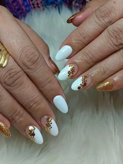 A chic and modern design with white nails and abstract gold glitter polka dots. This is a great way to add some sparkle while keeping the look sophisticated.