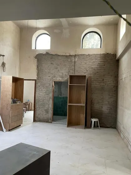 A space in the middle of its transformation. You can see the bones of the room, the mitti wall being prepped, and the arched windows waiting to be highlighted. The journey is just as important as the destination.