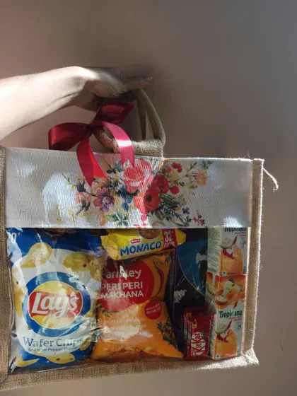 Another view of the wedding snack hamper, held up to show its contents. The clear window is a great feature that lets guests see the goodies inside.