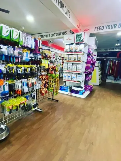 This wide view captures the breadth of our offerings, from the accessory racks in the foreground to the food and bedding sections in the back.