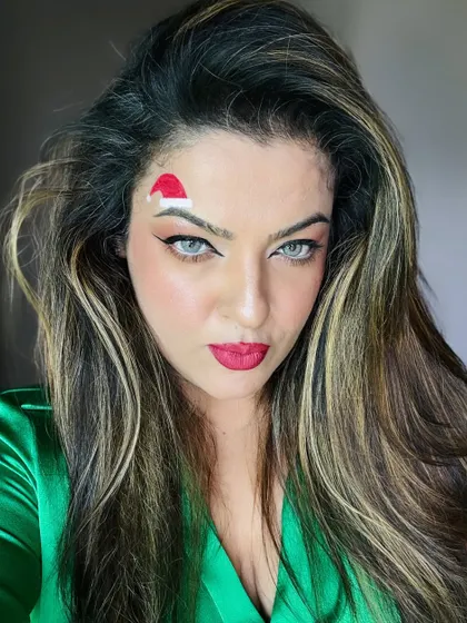 Feeling festive with this Christmas-themed makeup. The drawn-on Santa hat is a fun alternative to a real one, especially when you've spent time on your hair.