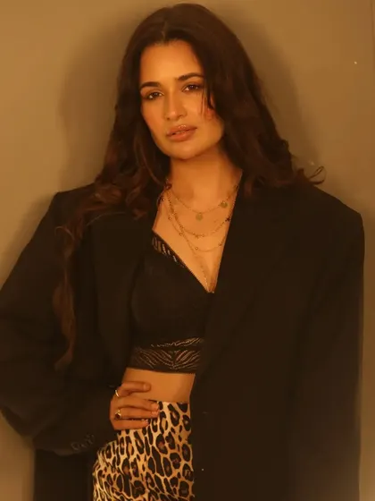 This shot highlights the layered necklaces and styling, with the makeup providing a clean and polished canvas. The look is chic and modern, with a timeless quality.